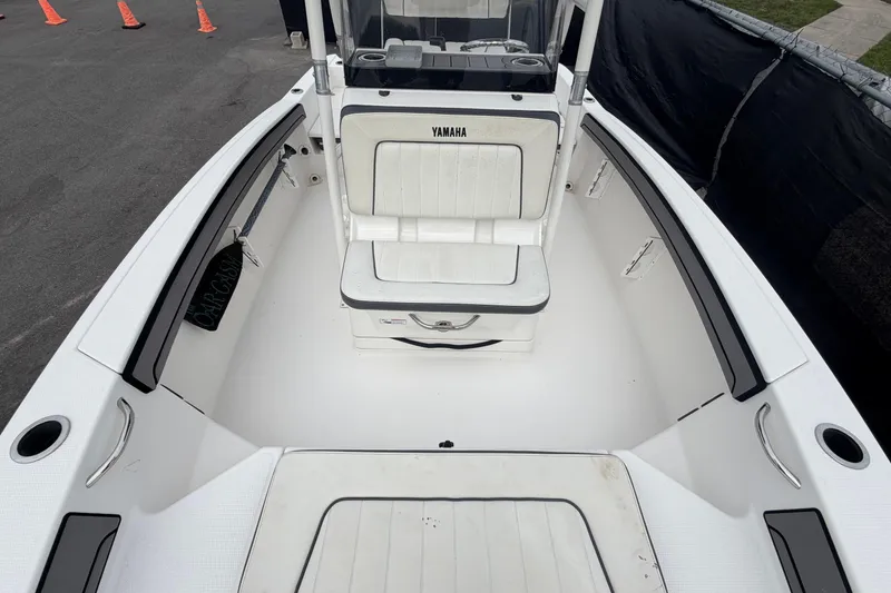 Slide: The Image of 2018 Yamaha Boats 190 FSH interior with white seating and storage compartments. - 42
