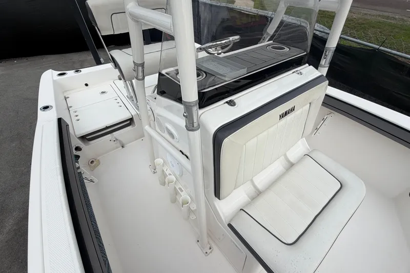 Slide: The Image of 2018 Yamaha Boats 190 FSH interior with seating and console, showcasing sleek design. - 46
