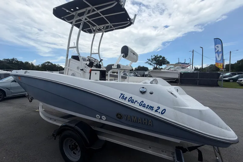 Slide: The Image of 2018 Yamaha Boats 190 FSH on trailer, featuring sleek design and custom name "The Oar-Gasm 2.0". - 5
