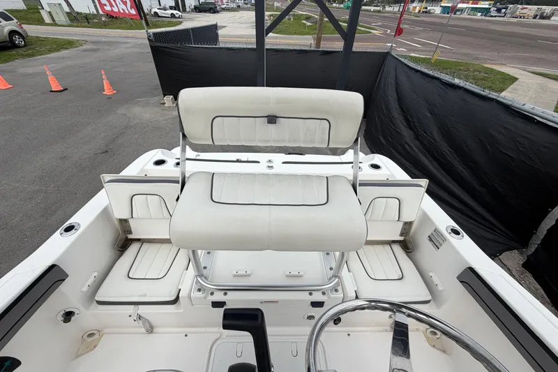 Slide: The Image of 2018 Yamaha Boats 190 FSH interior with white seating and steering wheel. - 53
