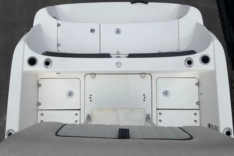 Slide: The Image of 2018 Yamaha Boats 190 FSH deck view, showcasing storage compartments and seating area. - 57