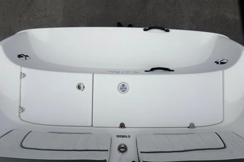 Slide: The Image of 2018 Yamaha Boats 190 FSH deck view, showcasing storage compartments and seating area. - 58