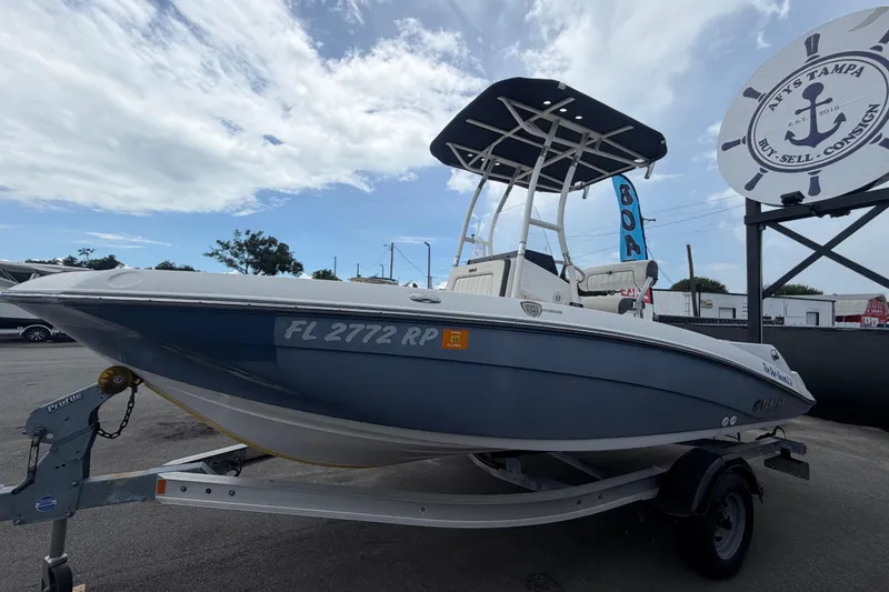 Slide: The Image of 2018 Yamaha Boats 190 FSH on trailer, displayed outdoors under a partly cloudy sky. - 7