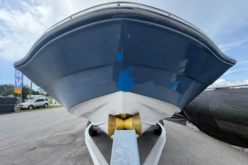 Slide: The Image of 2018 Yamaha Boats 190 FSH on trailer, blue hull, outdoor display. - 9