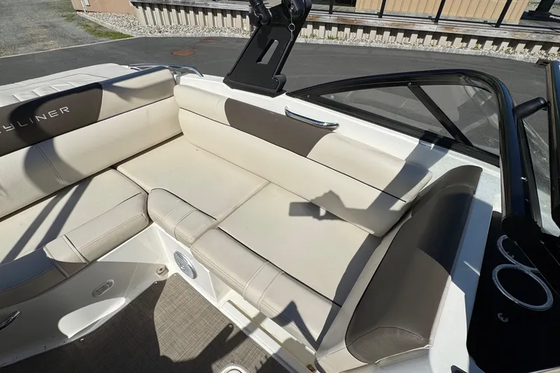 Slide: The Image of 2018 Bayliner 195 Deck Boat interior with beige seating and cup holders. - 4