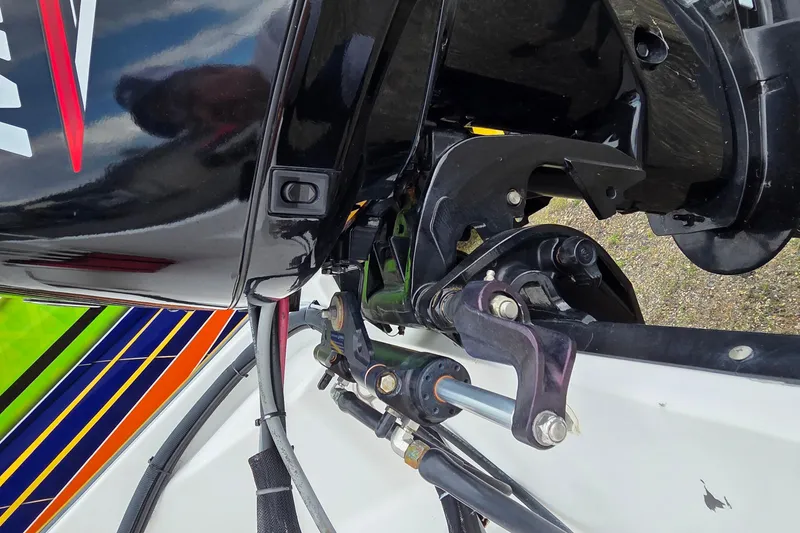 Slide: The Image of Close-up of a 2004 Boston Whaler 150 Sport boat engine and steering mechanism. - 12