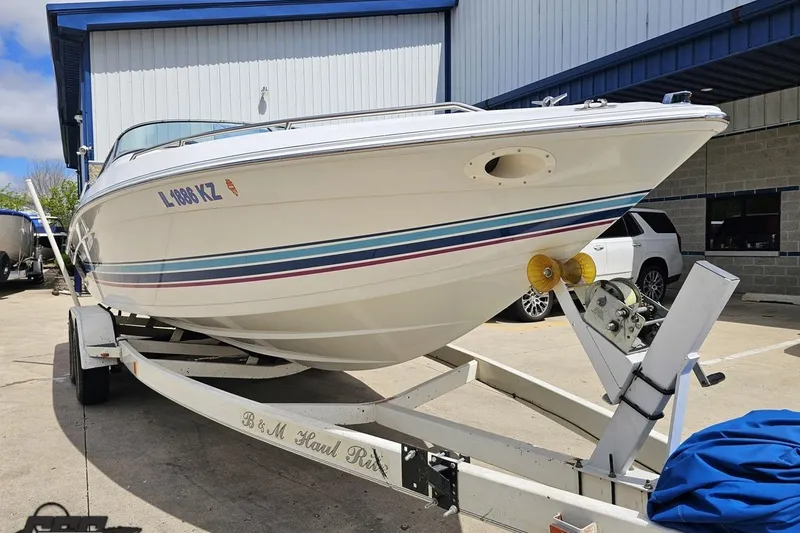 Slide: The Image of 1997 Formula 252 SS boat on trailer, parked outside a building. - 10
