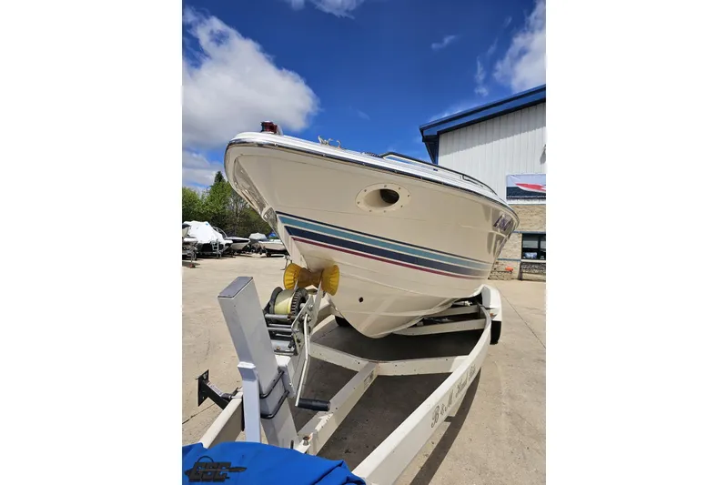 Slide: The Image of 1997 Formula 252 SS boat on trailer, outdoor setting, clear sky background. - 13