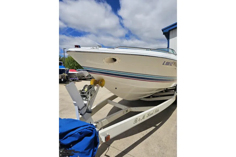 Slide: The Image of 1997 Formula 252 SS boat on trailer under a partly cloudy sky. - 14