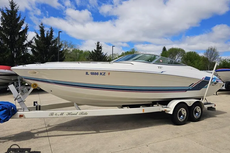 Slide: The Image of 1997 Formula 252 SS boat on trailer, parked outdoors under a partly cloudy sky. - 17