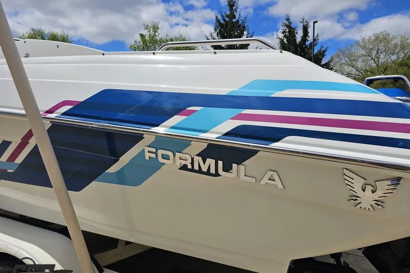 Slide: The Image of 1997 Formula 252 SS boat with colorful graphics and logo under a blue sky. - 25