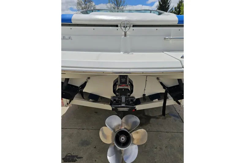 Slide: The Image of 1997 Formula 252 SS boat stern with propeller and outdrive, parked on concrete. - 29