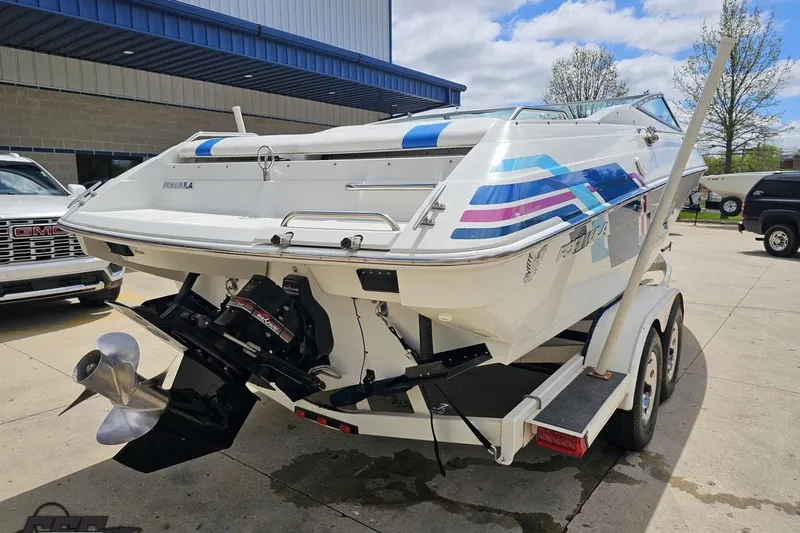Slide: The Image of 1997 Formula 252 SS boat on trailer, featuring colorful graphics and dual propeller. - 30