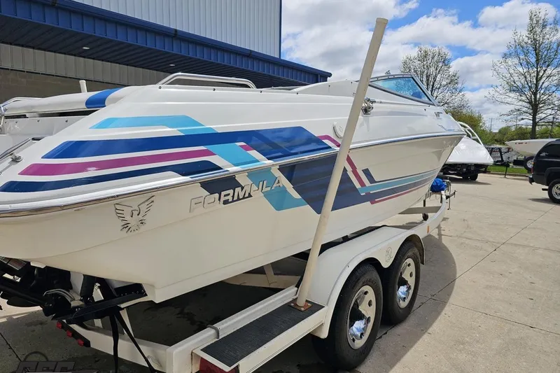 Slide: The Image of 1997 Formula 252 SS boat on trailer, featuring colorful graphics and sleek design. - 32