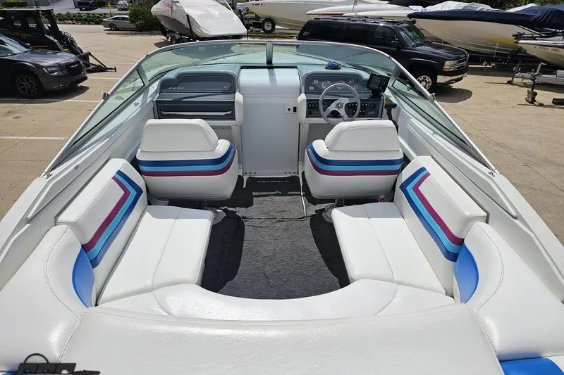 Slide: The Image of 1997 Formula 252 SS boat interior with white seating and colorful accents. - 36