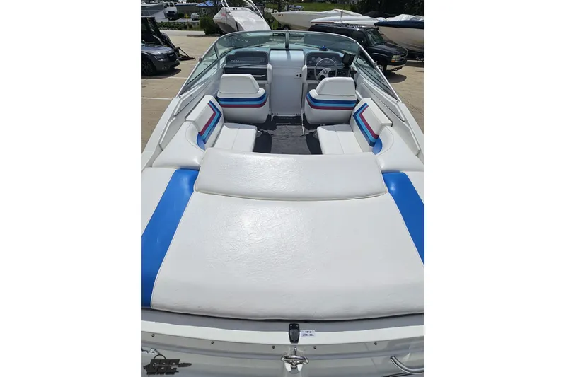Slide: The Image of 1997 Formula 252 SS boat interior with white and blue seating, docked outdoors. - 37