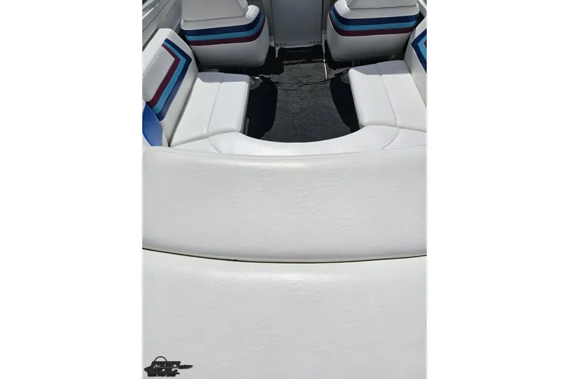 Slide: The Image of Interior seating of a 1997 Formula 252 SS boat with white upholstery and colorful accents. - 41