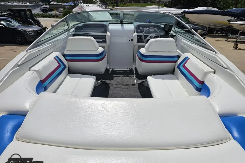 Slide: The Image of 1997 Formula 252 SS boat interior with white and colorful striped seating. - 43