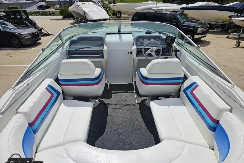 Slide: The Image of 1997 Formula 252 SS boat interior with white seating and colorful accents. - 45