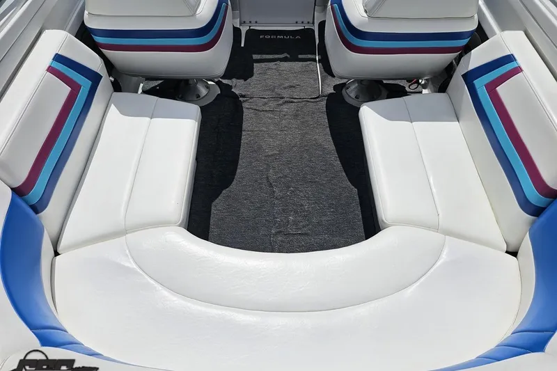 Slide: The Image of Interior of a 1997 Formula 252 SS boat with white and blue seating. - 46