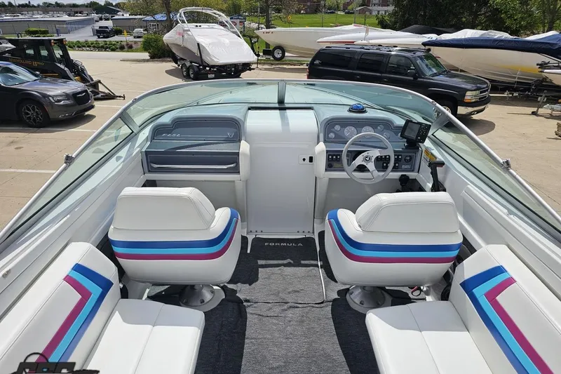 Slide: The Image of 1997 Formula 252 SS boat interior with white seating and colorful accents. - 47