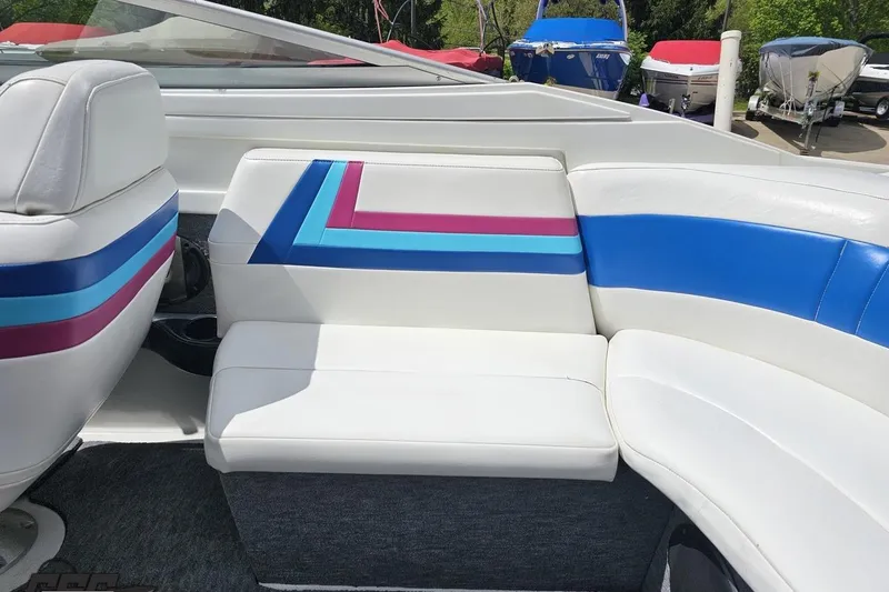 Slide: The Image of 1997 Formula 252 SS boat interior with white seats and colorful stripes. - 48