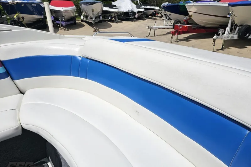 Slide: The Image of 1997 Formula 252 SS boat interior with blue and white seating, docked among other boats. - 49