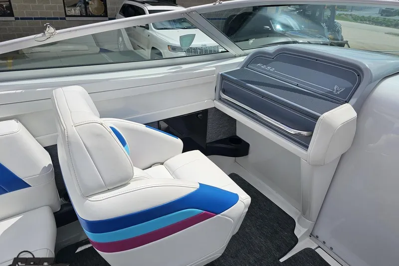 Slide: The Image of Interior of a 1997 Formula 252 SS boat with white and blue seating. - 52