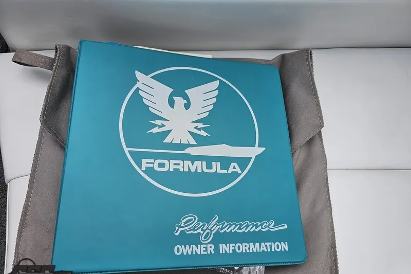 Slide: The Image of Teal Formula 252 SS 1997 owner's manual with logo on a white seat. - 57