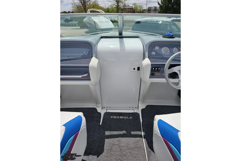 Slide: The Image of Interior view of a 1997 Formula 252 SS boat cockpit with steering wheel and dashboard. - 58