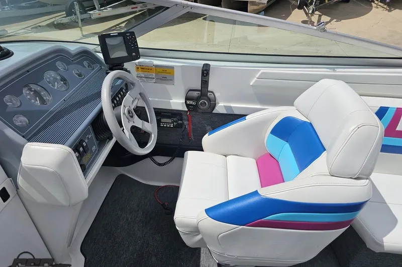 Slide: The Image of Interior of a 1997 Formula 252 SS boat with colorful seating and dashboard controls. - 60