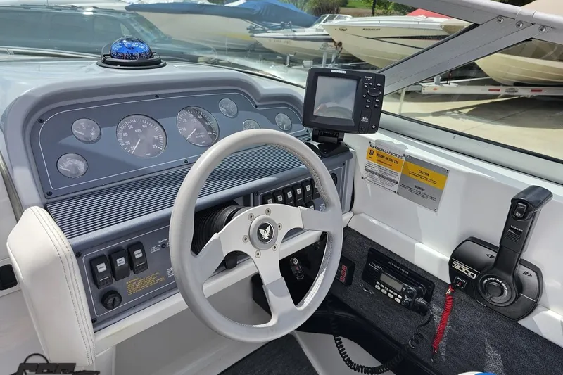 Slide: The Image of Interior view of a 1997 Formula 252 SS boat dashboard with steering wheel and controls. - 63