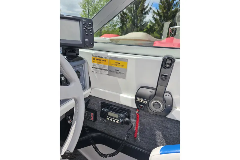 Slide: The Image of Interior view of a 1997 Formula 252 SS boat dashboard with controls and navigation equipment. - 68