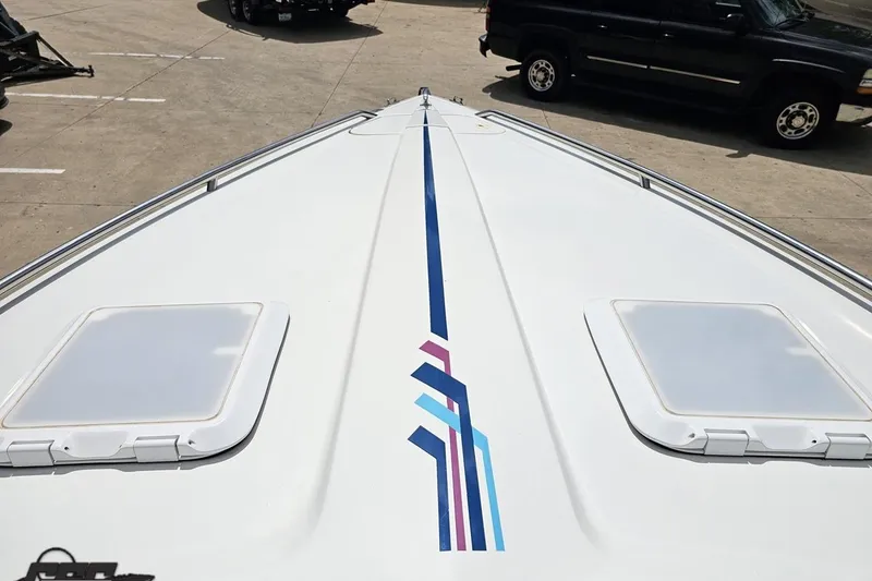 Slide: The Image of Bow view of 1997 Formula 252 SS boat with colorful stripe design. - 70