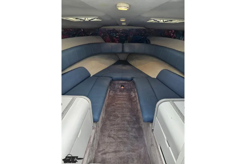 Slide: The Image of Interior of a 1997 Formula 252 SS boat with blue seating and carpeted floor. - 71