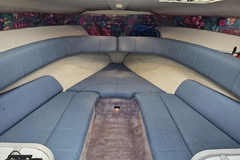 Slide: The Image of Interior cabin of a 1997 Formula 252 SS boat with blue seating and patterned walls. - 72