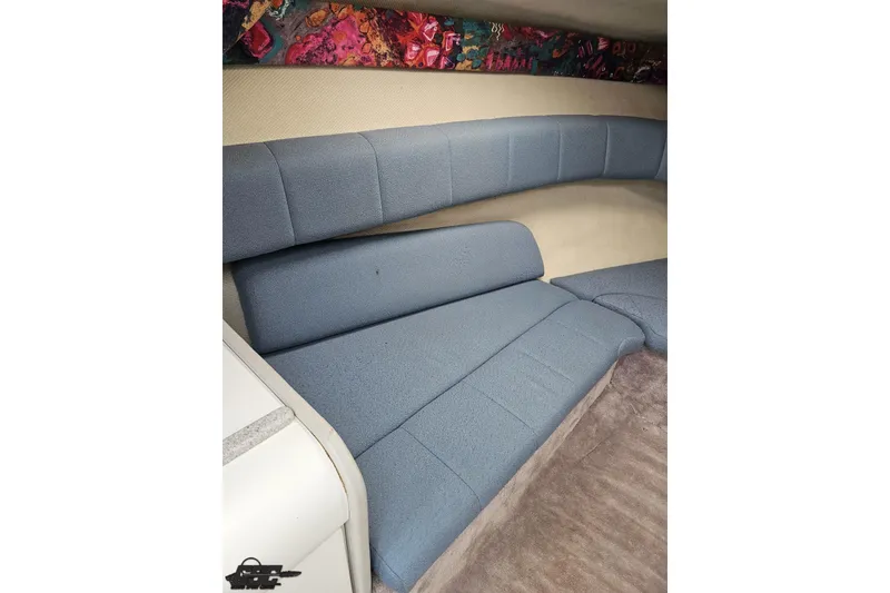 Slide: The Image of Interior of a 1997 Formula 252 SS boat with blue cushioned seating. - 75
