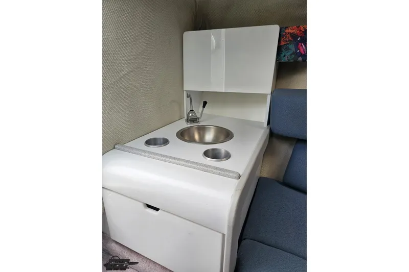 Slide: The Image of 1997 Formula 252 SS boat interior with compact sink and seating area. - 76