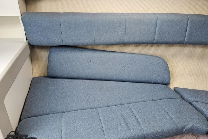 Slide: The Image of Interior seating of a 1997 Formula 252 SS boat, featuring blue upholstery. - 77