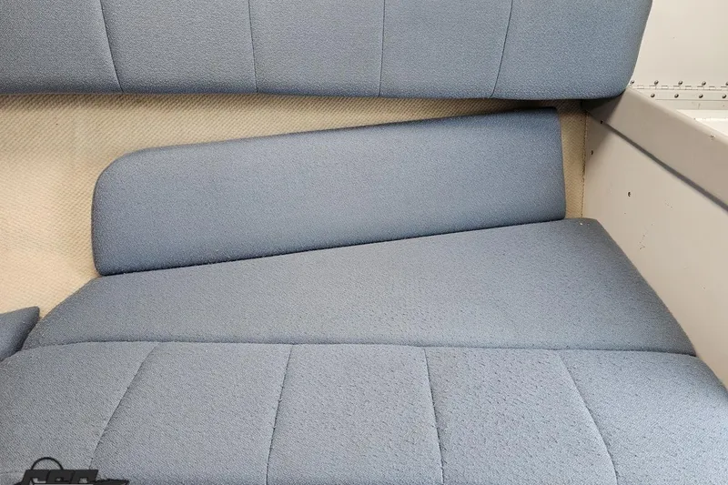Slide: The Image of Blue upholstered seating in a 1997 Formula 252 SS boat interior. - 79