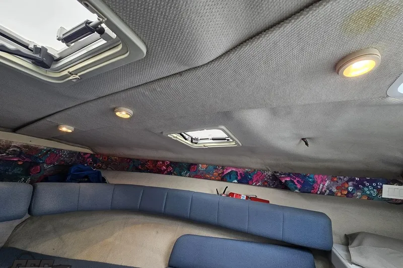 Slide: The Image of Interior of a 1997 Formula 252 SS boat with blue seating and colorful accents. - 80