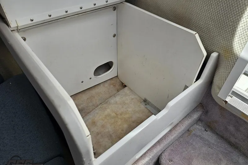 Slide: The Image of Interior storage compartment of a 1997 Formula 252 SS boat, showing empty space. - 82