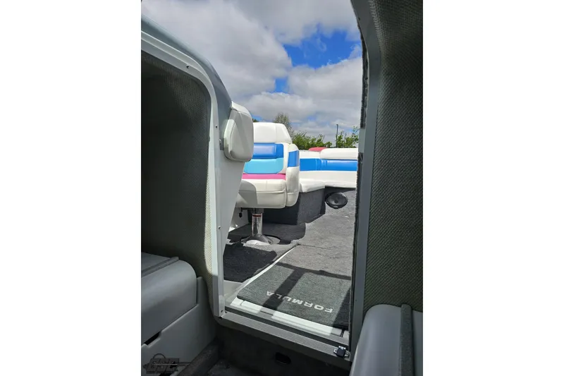 Slide: The Image of Interior view of a 1997 Formula 252 SS boat with colorful seating and carpet. - 83