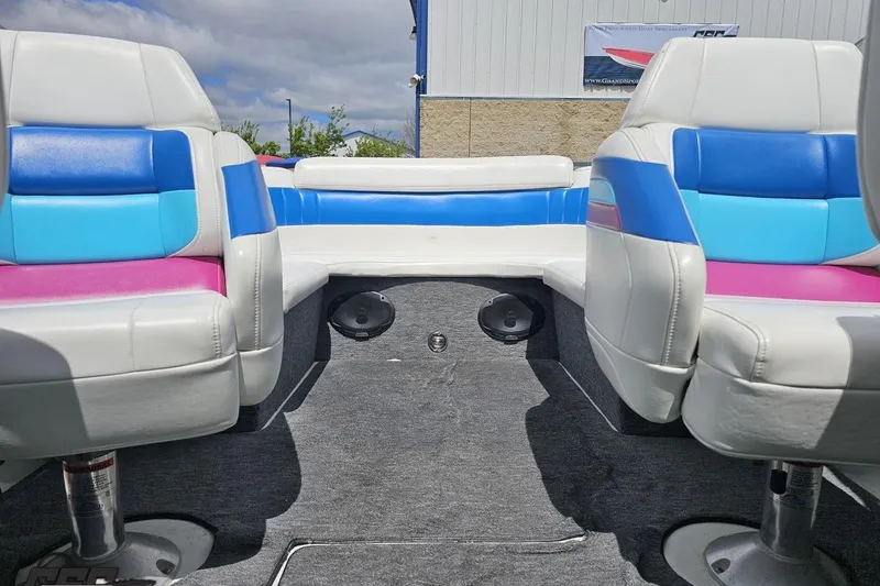 Slide: The Image of Interior of a 1997 Formula 252 SS boat with colorful seating and carpeted flooring. - 84