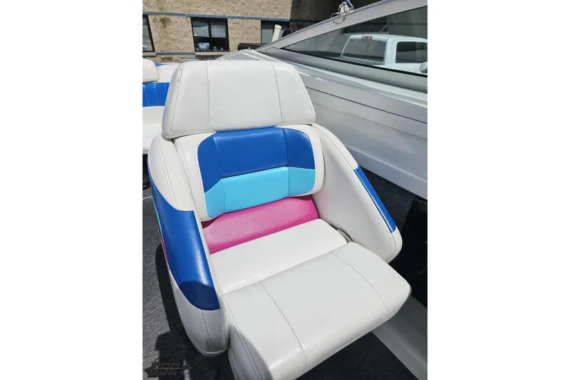 Slide: The Image of Colorful boat seat in a 1997 Formula 252 SS, featuring blue, pink, and white upholstery. - 87