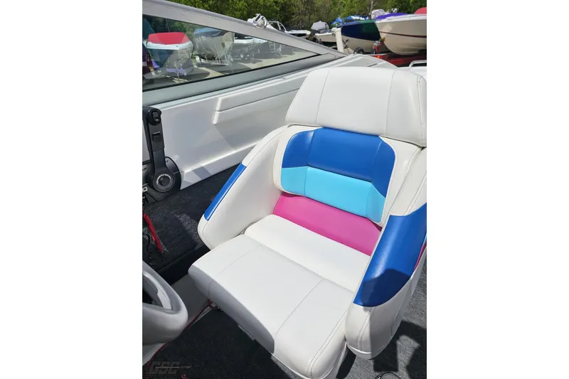Slide: The Image of Colorful seat in a 1997 Formula 252 SS boat, featuring blue, pink, and white upholstery. - 88