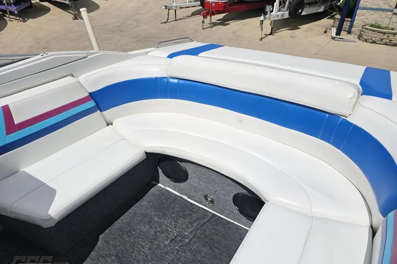 Slide: The Image of 1997 Formula 252 SS boat interior with white and blue seating, showcasing a spacious layout. - 89