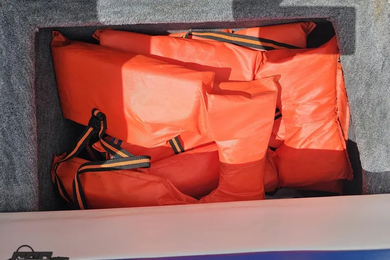 Slide: The Image of Orange life jackets stored in a compartment of a 1997 Formula 252 SS boat. - 93