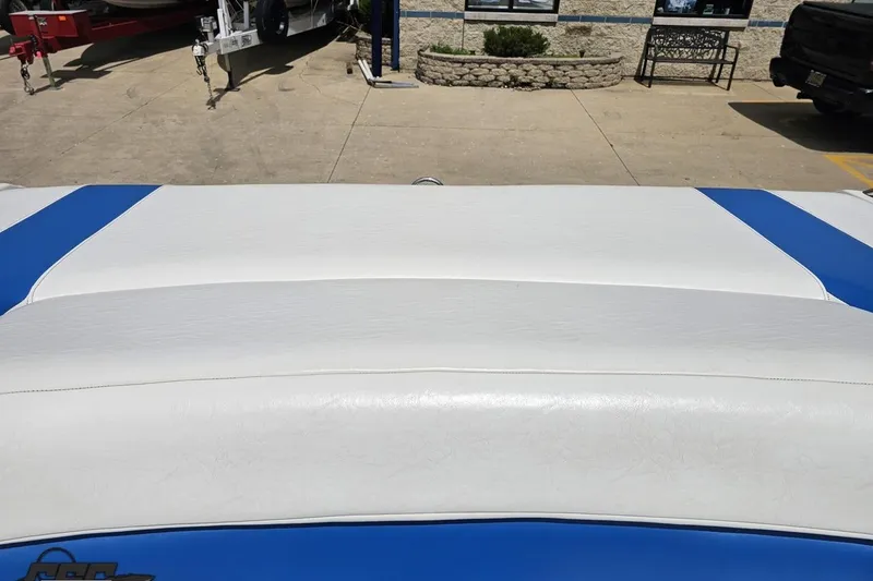 Slide: The Image of 1997 Formula 252 SS boat interior with white and blue upholstery, parked outdoors. - 96