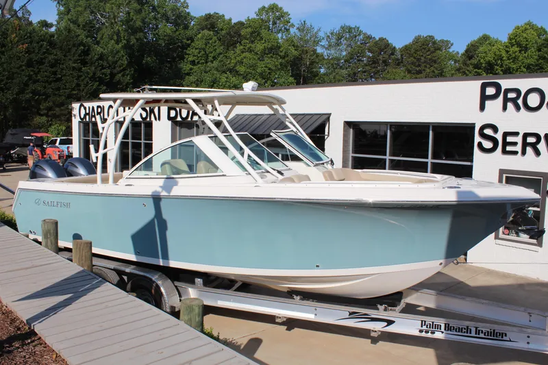 The Image of 2017 Sailfish 275 DC boat on trailer at dealership, side view. - 1